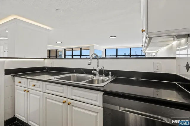a bathroom with a shower curtain and a large window