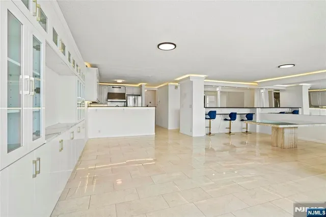 a bathroom with a granite countertop sink a toilet and a mirror