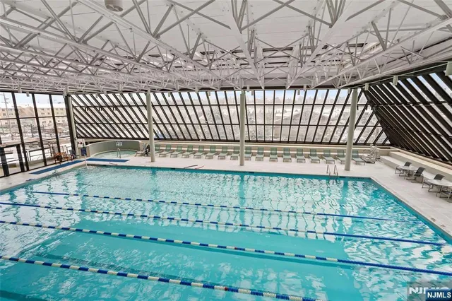 a view of a backyard with swimming pool