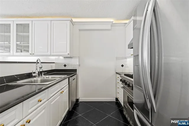 a kitchen with a sink and a refrigerator