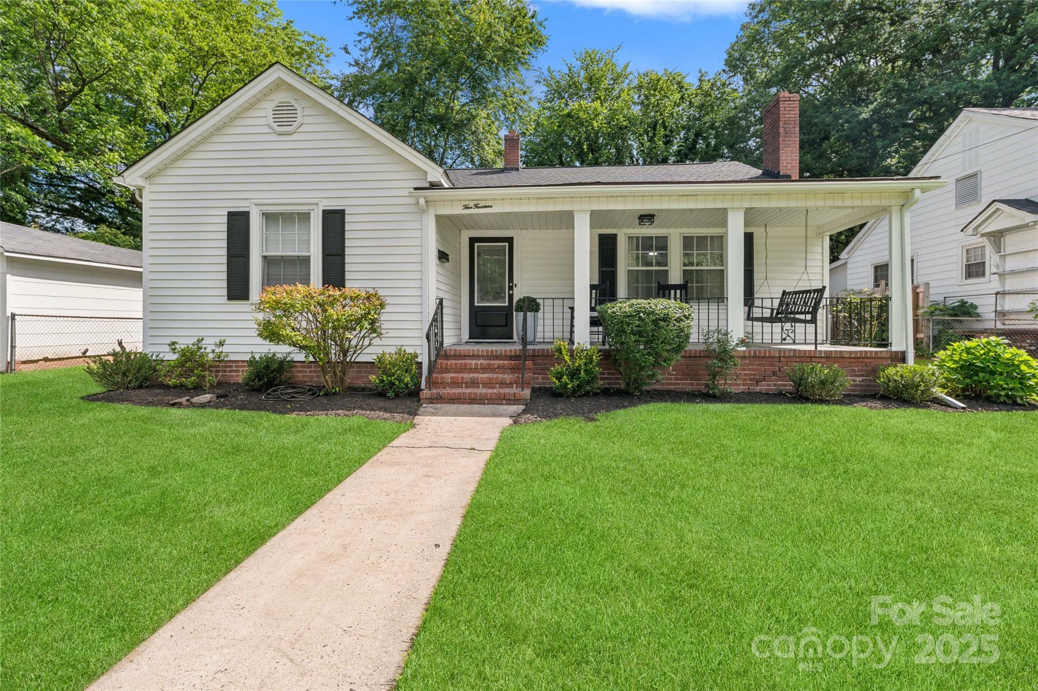 a view of a house with a yard and plants