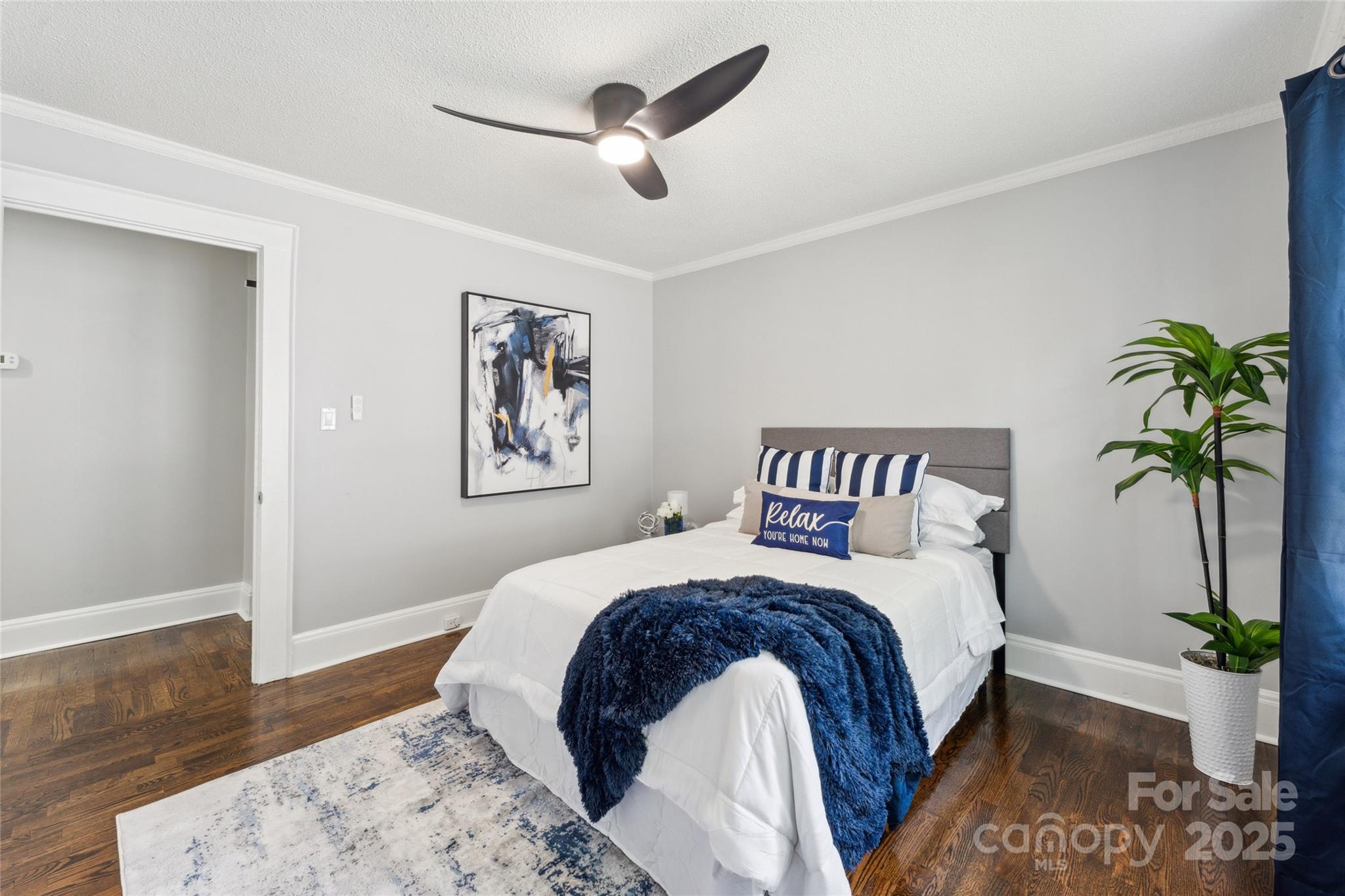 514 West 8th Avenue Gastonia, NC 28052 - Photo 14 of 19 a bedroom with a large bed and a chandelier