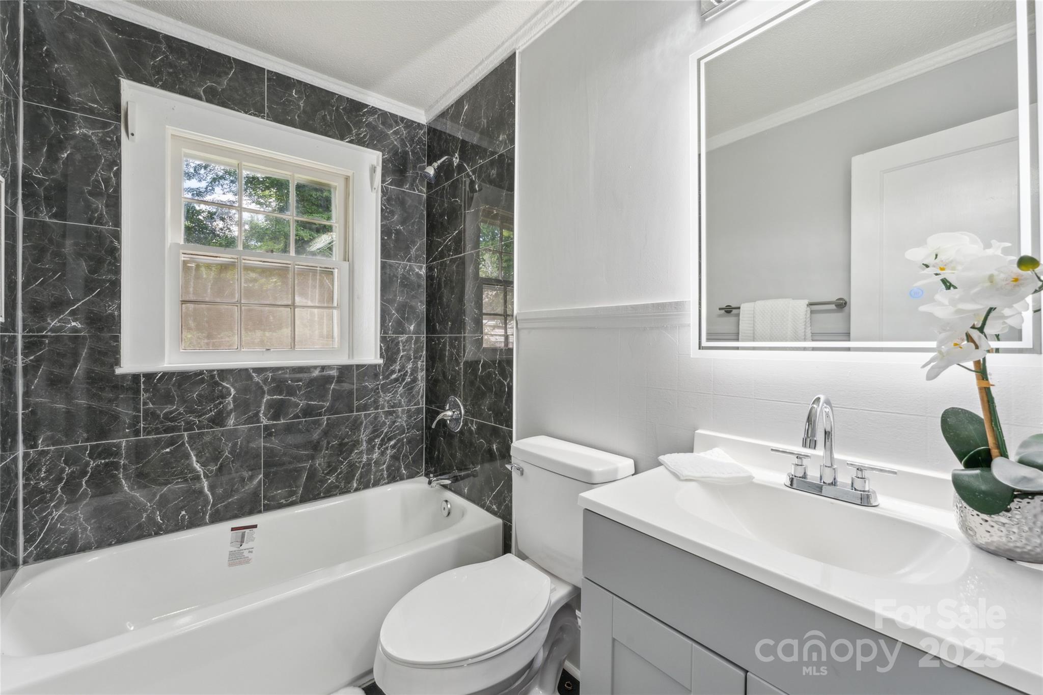 514 West 8th Avenue Gastonia, NC 28052 - Photo 16 of 19 a bathroom with a sink a toilet and shower