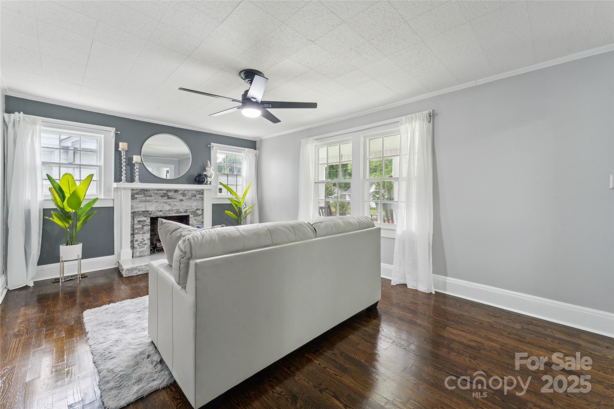 514 West 8th Avenue Gastonia, NC 28052 - Photo 8 of 19 a living room with furniture a fireplace and a wooden floor