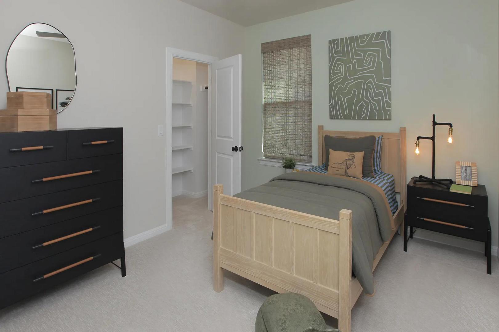 2033 Morning Mist Drive Georgetown, TX 78628 - Photo 31 of 36 a bedroom with a bed and a lamp on dresser