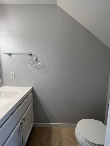 a bathroom with a sink a toilet and vanity