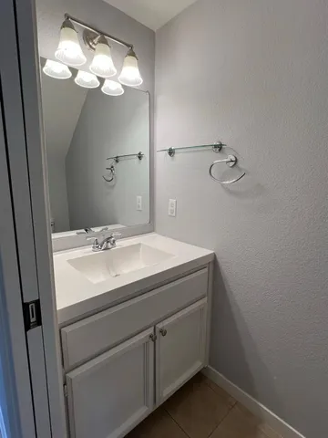 a bathroom with a sink vanity and a mirror