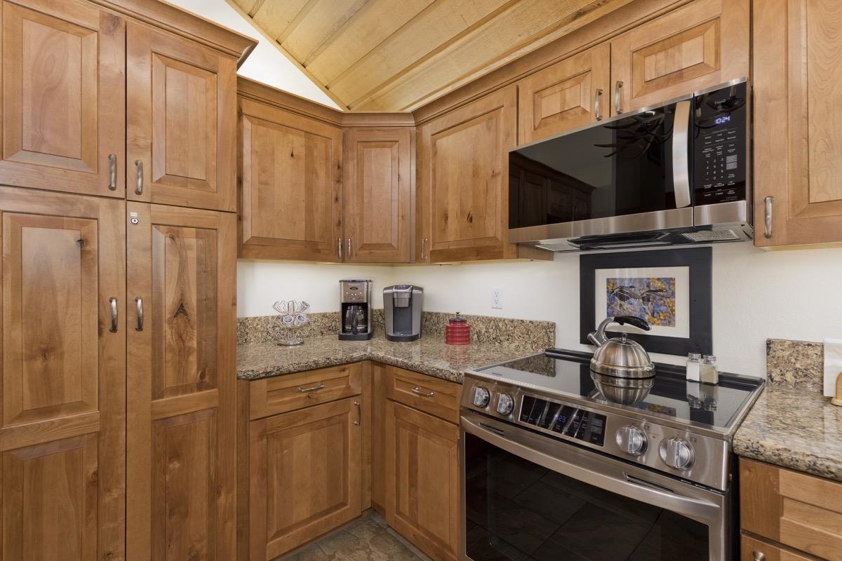 61 Goldhill, Unit 61 Mammoth Lakes, CA 93546 - Photo 18 of 44 a kitchen with stainless steel appliances granite countertop a stove a sink and a microwave