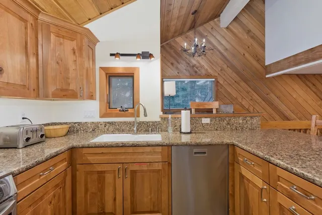 a bathroom with a granite countertop sink a mirror and vanity