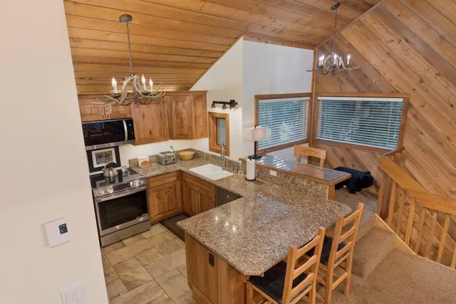 a backyard of a house with barbeque oven and outdoor seating