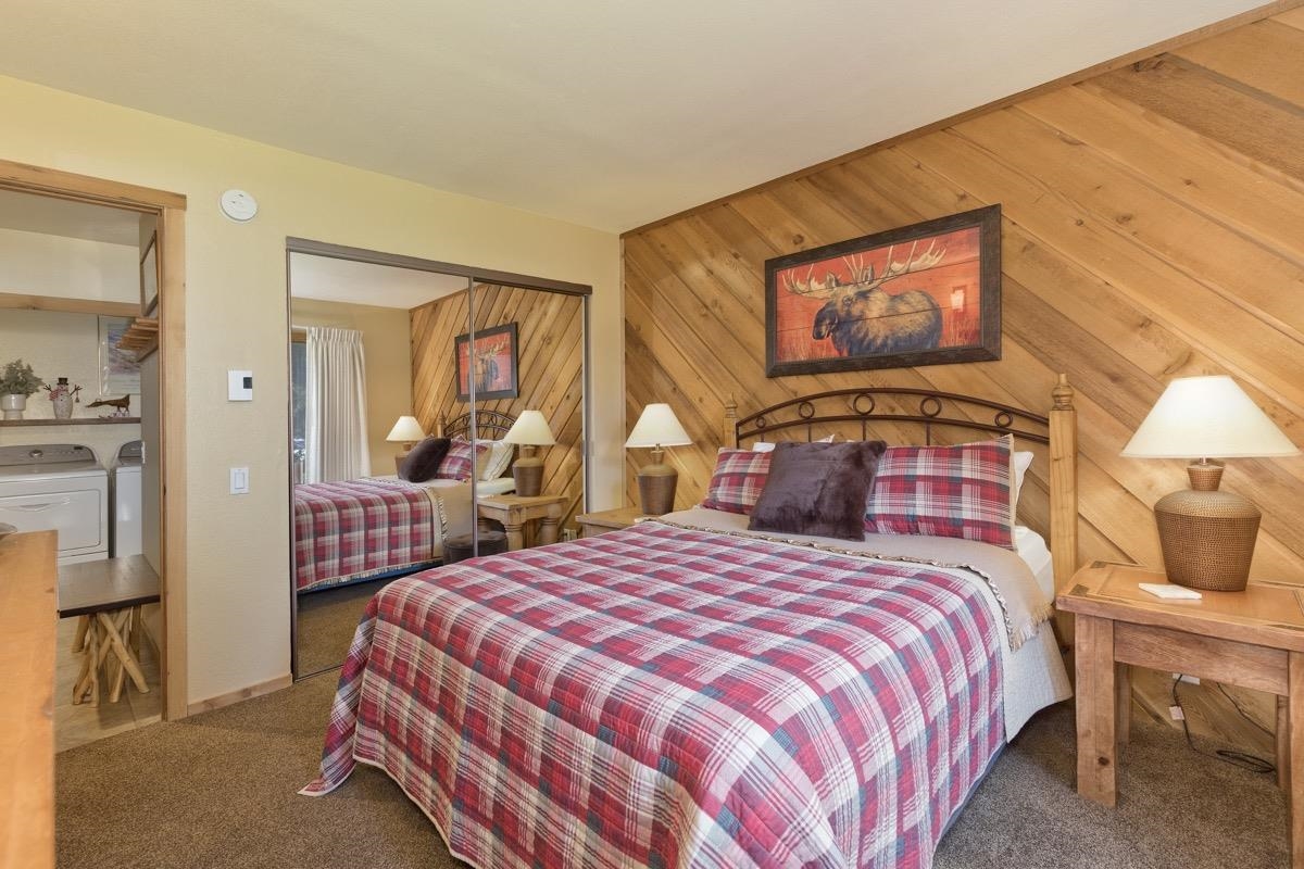 61 Goldhill, Unit 61 Mammoth Lakes, CA 93546 - Photo 33 of 44 a bedroom with a bed and wooden floor