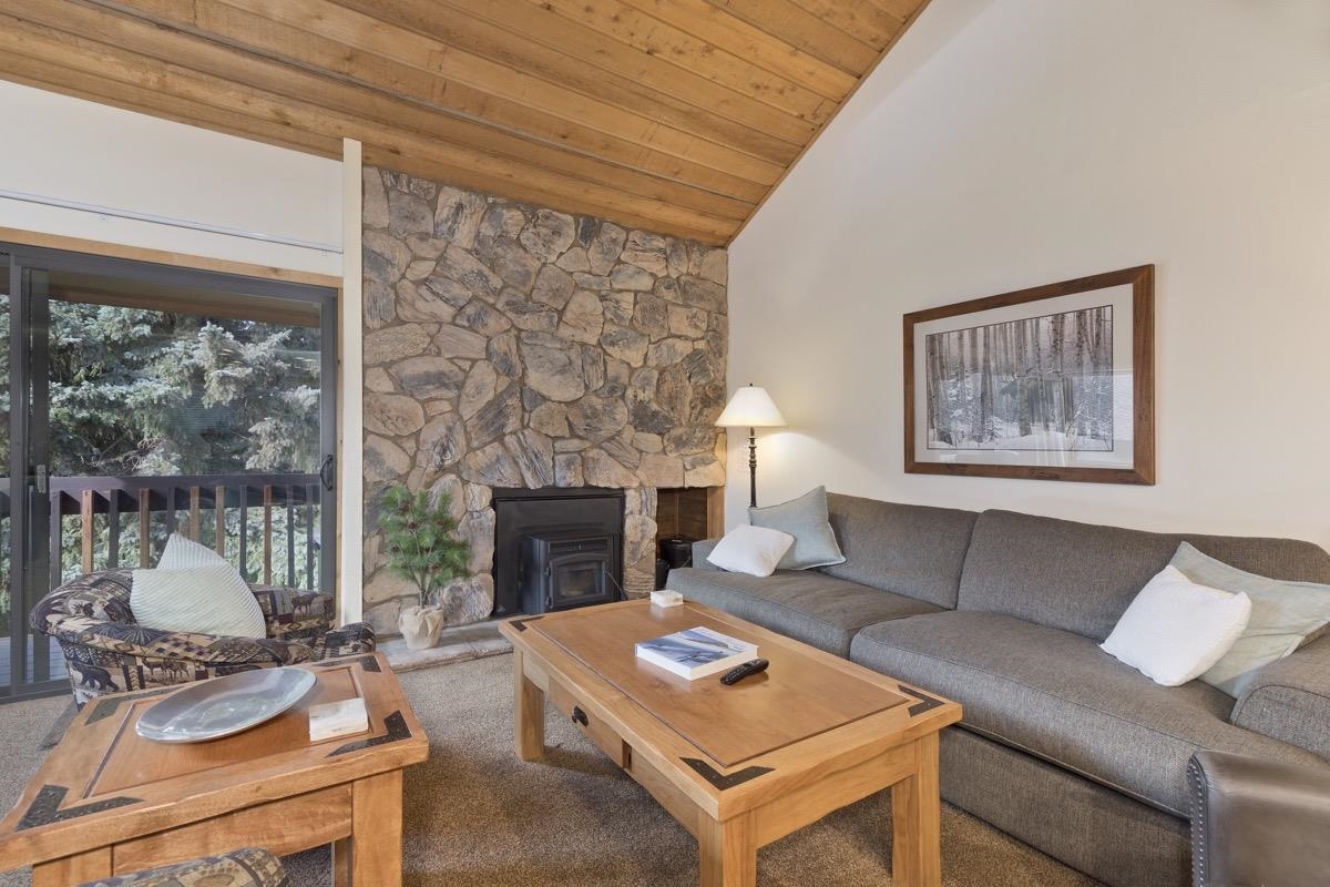 61 Goldhill, Unit 61 Mammoth Lakes, CA 93546 - Photo 10 of 44 a living room with furniture a table and a fireplace