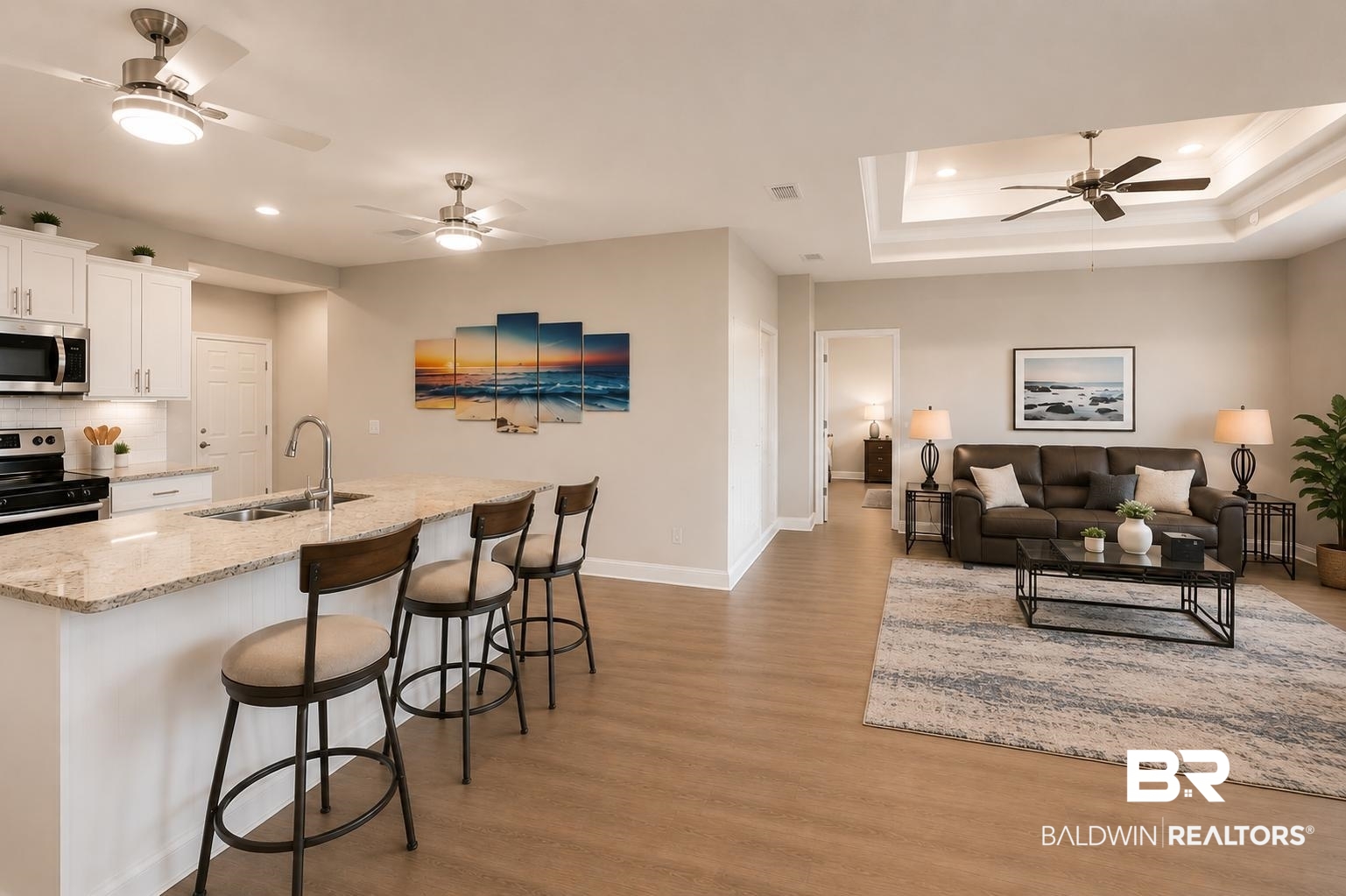 31468 Memphis Loop Daphne, AL 36527 - Photo 8 of 24 Open-concept living space featuring wood-finish flooring throughout, a kitchen island with stone countertop and sink, stainless steel appliances, white cabinetry, and recessed lighting