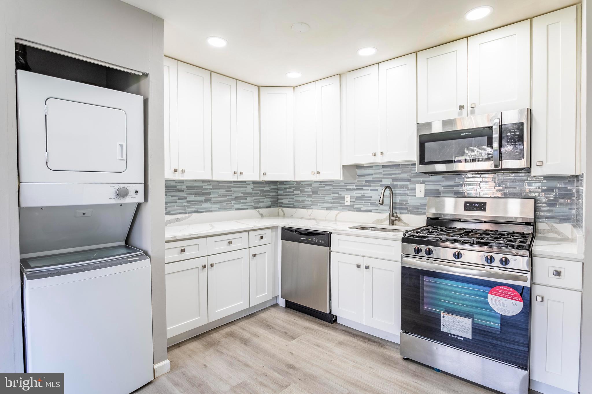 8467 Greenbelt Road, Unit 8467102 Greenbelt, MD 20770 - Photo 13 of 30 a kitchen with stainless steel appliances granite countertop a stove a sink and a microwave