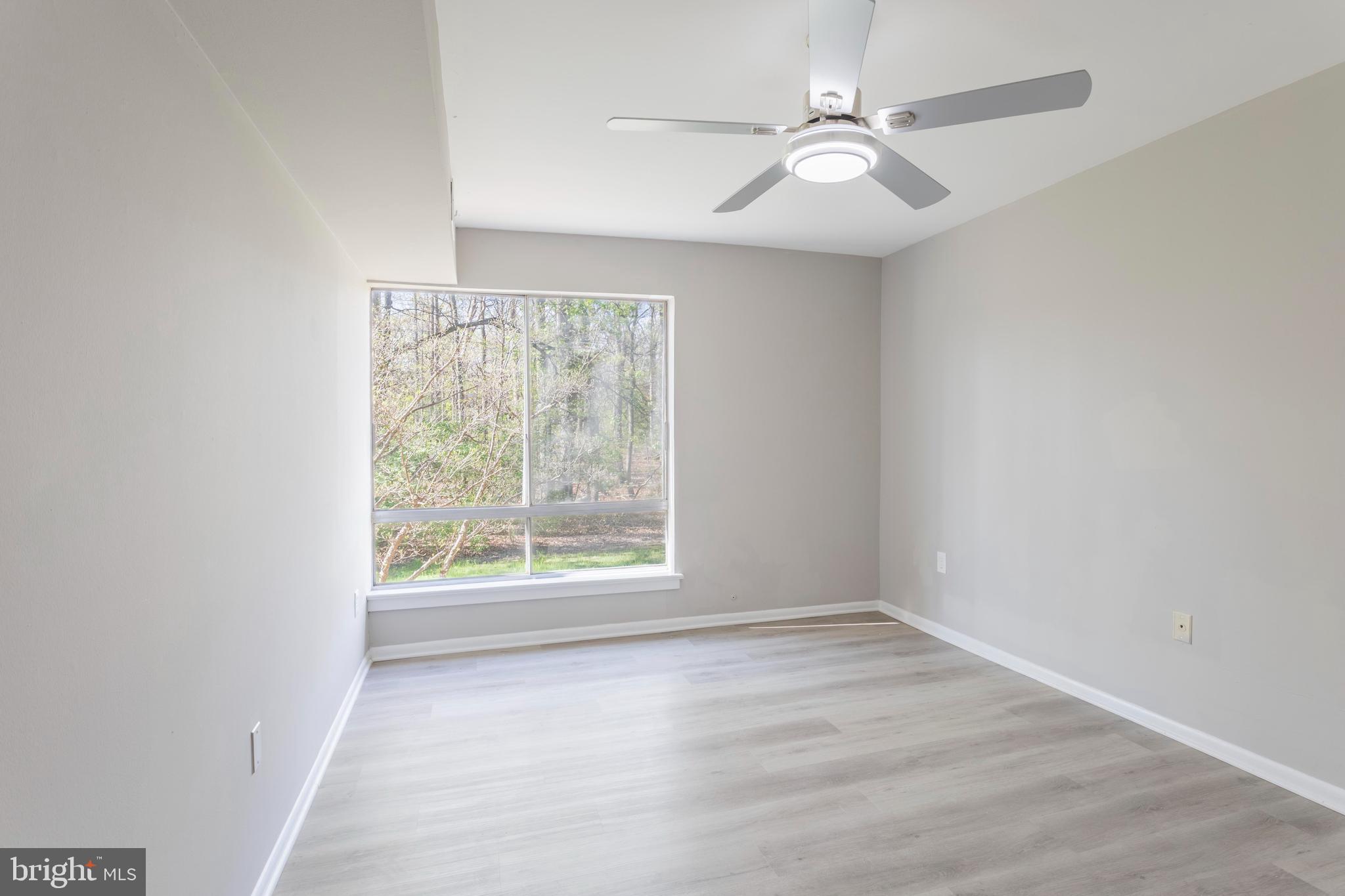 8467 Greenbelt Road, Unit 8467102 Greenbelt, MD 20770 - Photo 20 of 30 an empty room with windows and fan