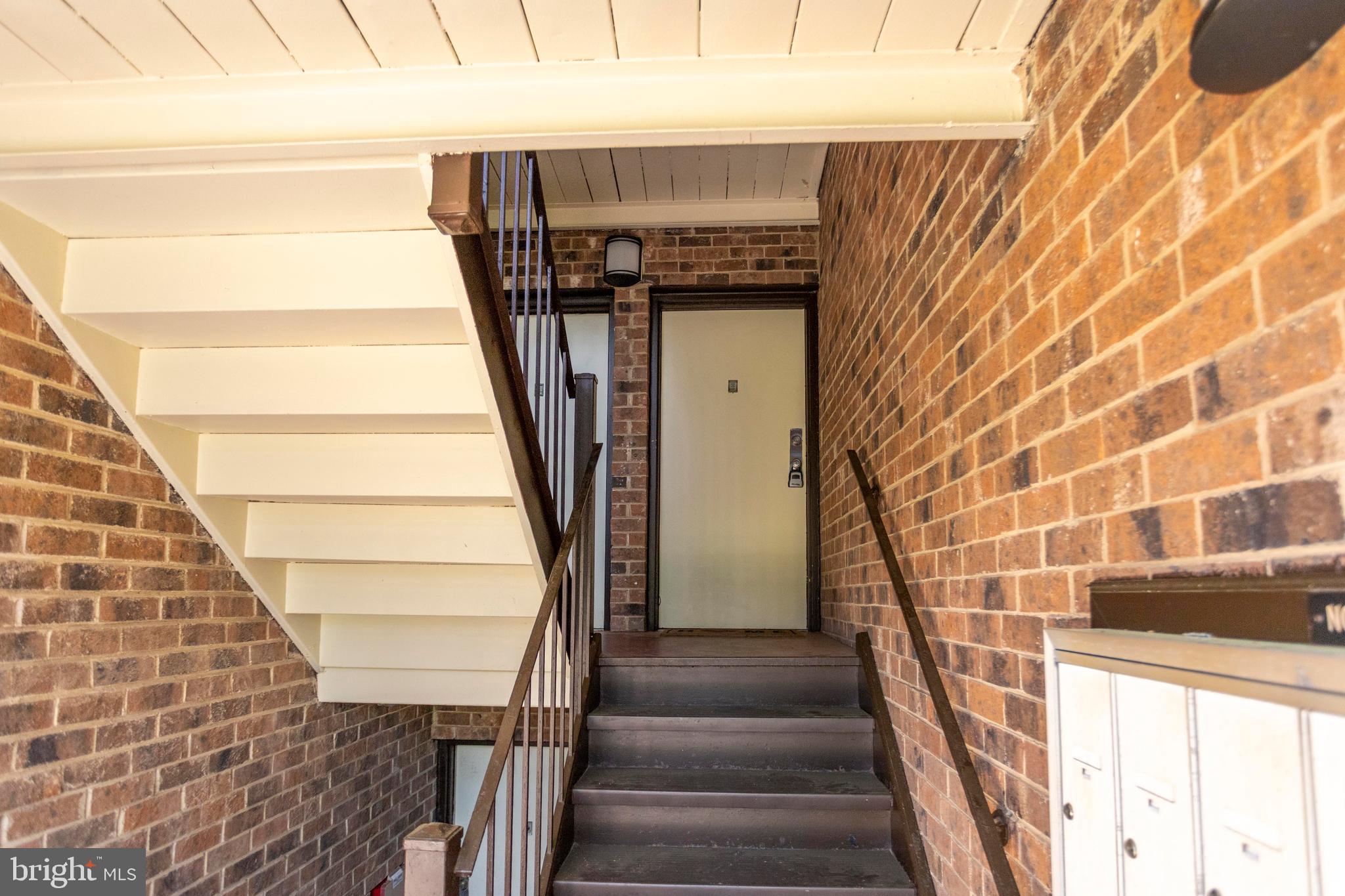 8467 Greenbelt Road, Unit 8467102 Greenbelt, MD 20770 - Photo 28 of 30 a view of entryway with wooden floor and stairs