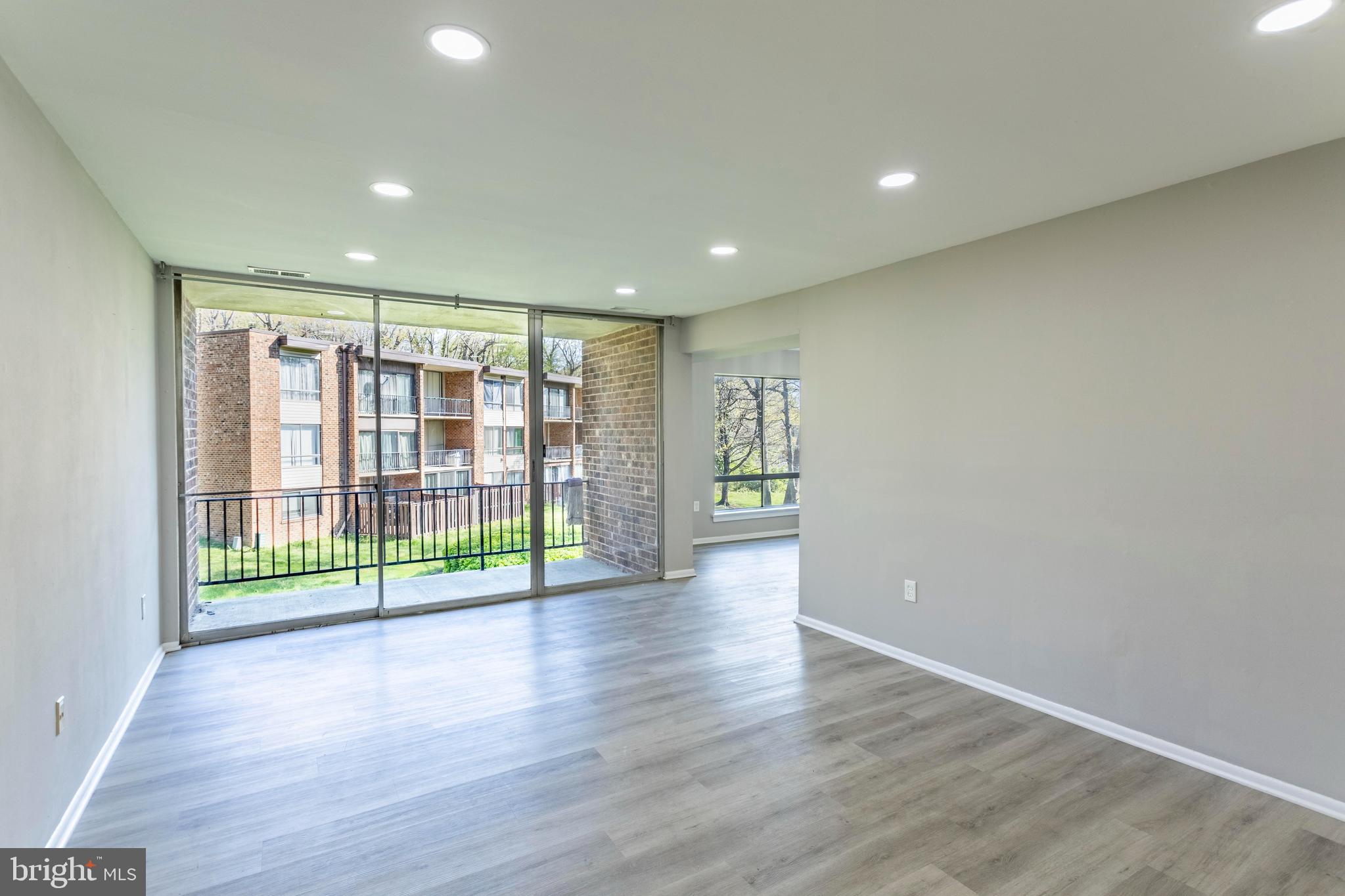 8467 Greenbelt Road, Unit 8467102 Greenbelt, MD 20770 - Photo 5 of 30 a view of room with wooden floor