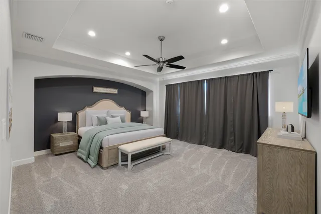 a bed room with a bed and a ceiling fan
