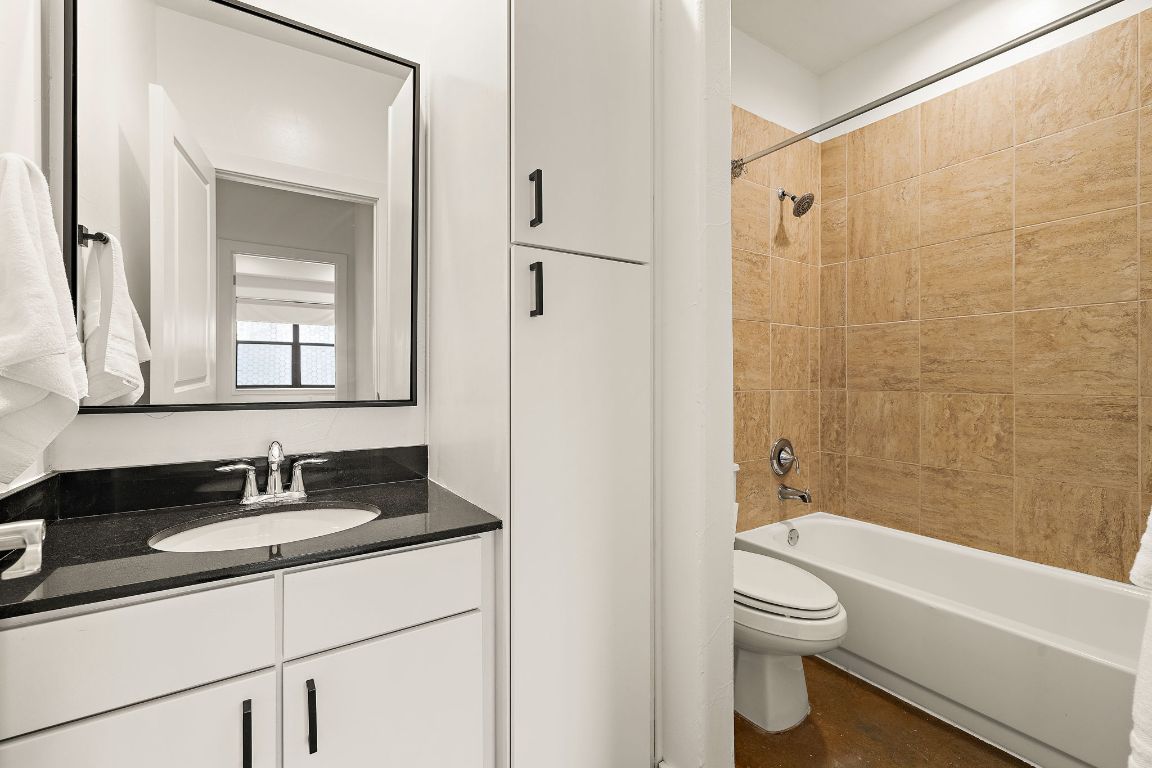1807 Poquito Street, Unit 41 Austin, TX 78702 - Photo 17 of 23 a bathroom with a granite countertop sink toilet and shower