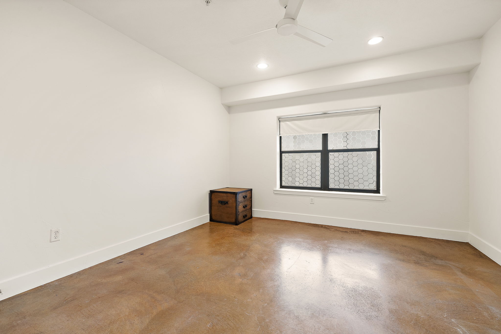 1807 Poquito Street, Unit 41 Austin, TX 78702 - Photo 19 of 23 Empty room with finished concrete floors, a ceiling fan, and recessed lighting