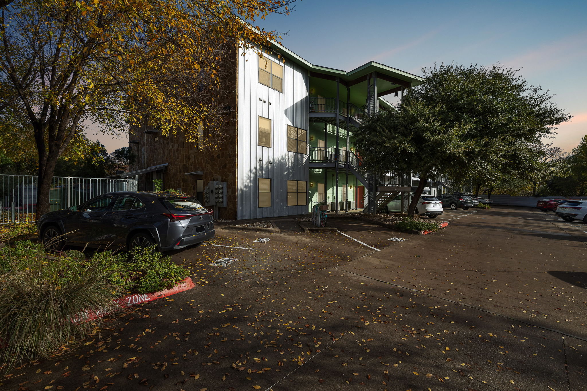 1807 Poquito Street, Unit 41 Austin, TX 78702 - Photo 2 of 23 Property at dusk with uncovered parking and stairway