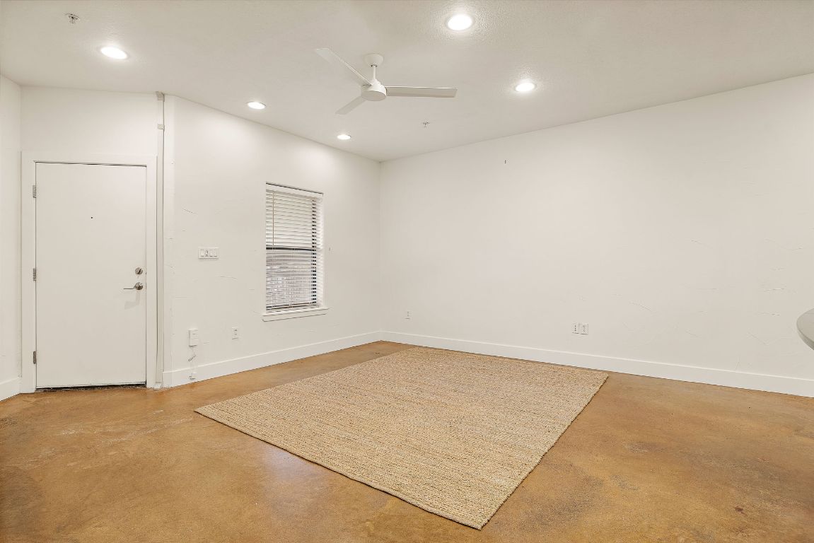 1807 Poquito Street, Unit 41 Austin, TX 78702 - Photo 6 of 23 an empty room with windows & cabinet