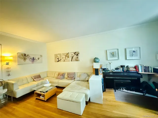 a living room with furniture and paintings on the wall