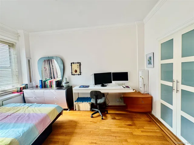 a bedroom with a bed and a desk