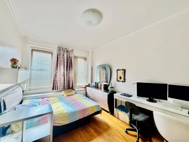 a bedroom with a bed and a television