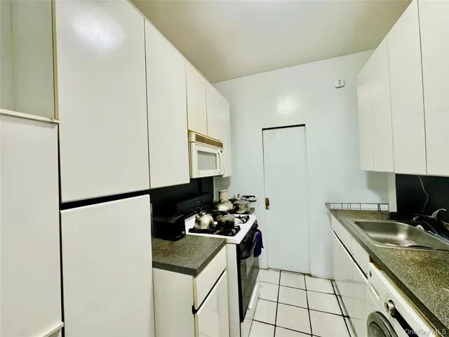 a kitchen with a sink and a refrigerator