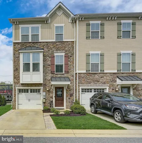a car parked in front of a brick house