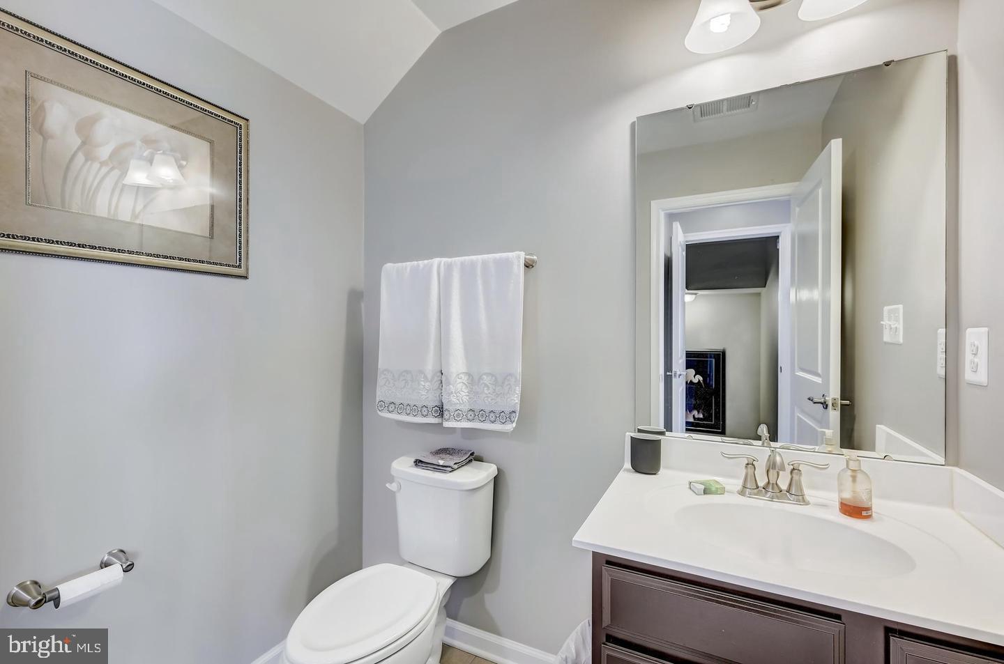8102 Secluded Cove Lane Baltimore, MD 21222 - Photo 14 of 23 a bathroom with a toilet a sink and mirror