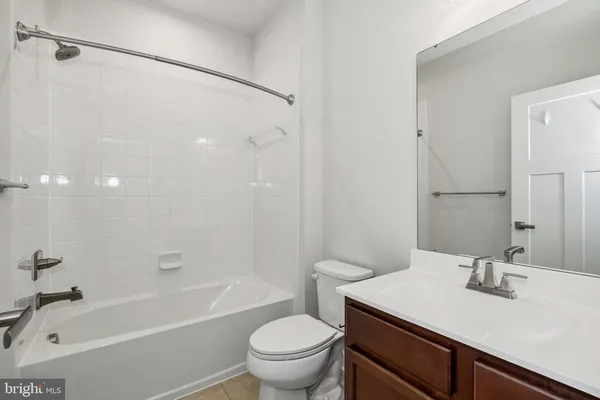 a bathroom with a sink toilet vanity and shower