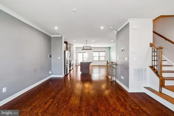 a view of empty room with wooden floor
