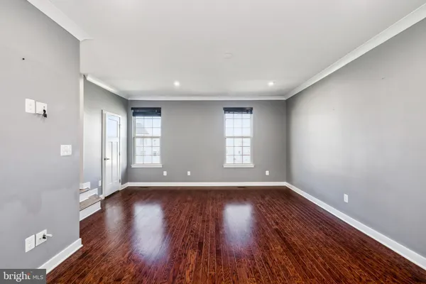 a view of wooden floor and windows in a room