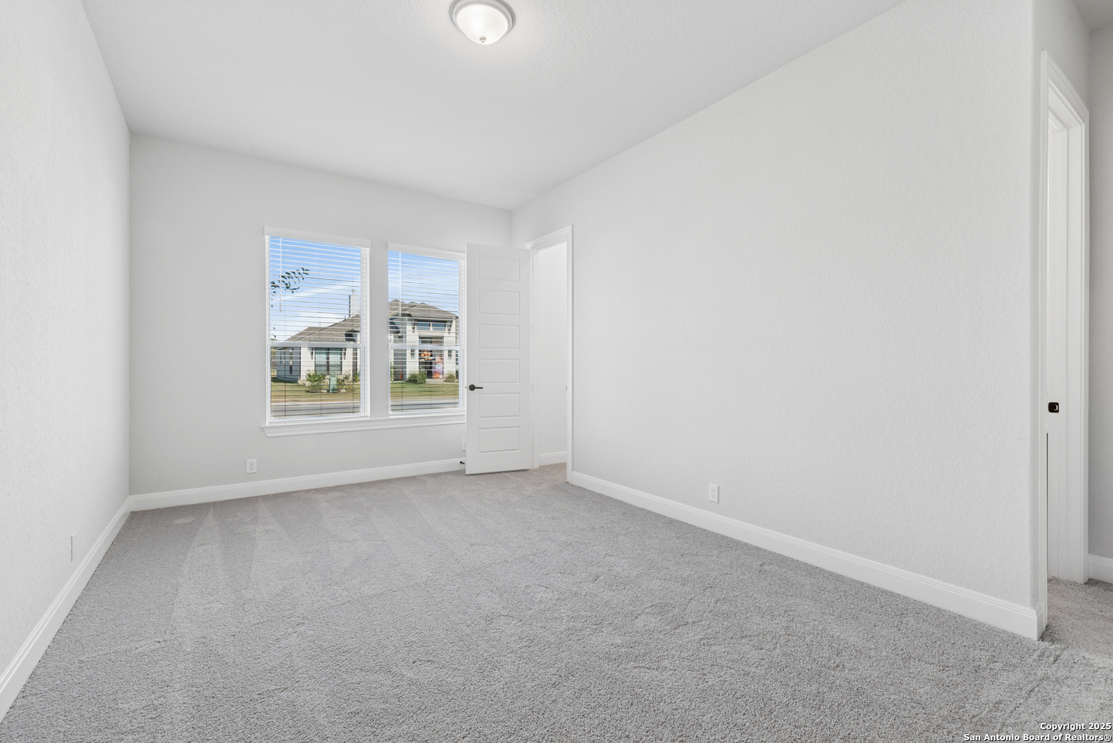 212 Brandon Cove Castroville, TX 78009 - Photo 18 of 36 an empty room with windows