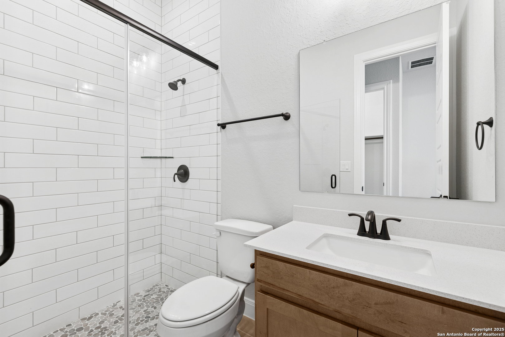 212 Brandon Cove Castroville, TX 78009 - Photo 22 of 36 a bathroom with a sink a toilet and shower