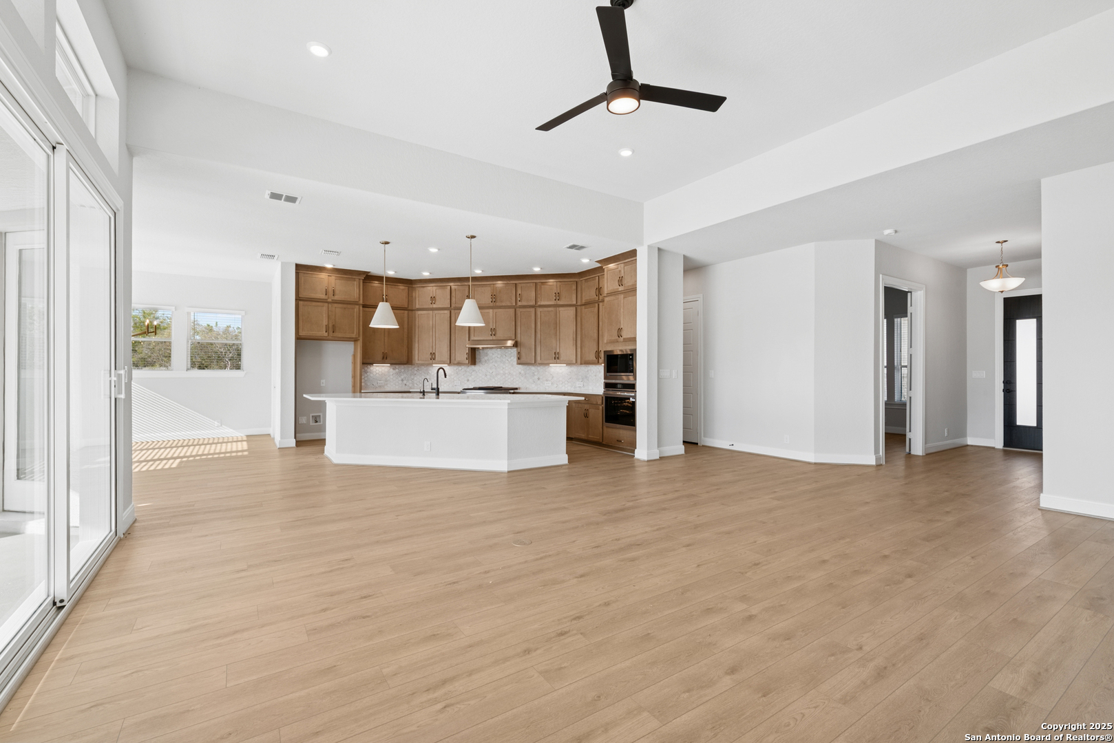 212 Brandon Cove Castroville, TX 78009 - Photo 27 of 36 a view of a kitchen with a sink and a refrigerator