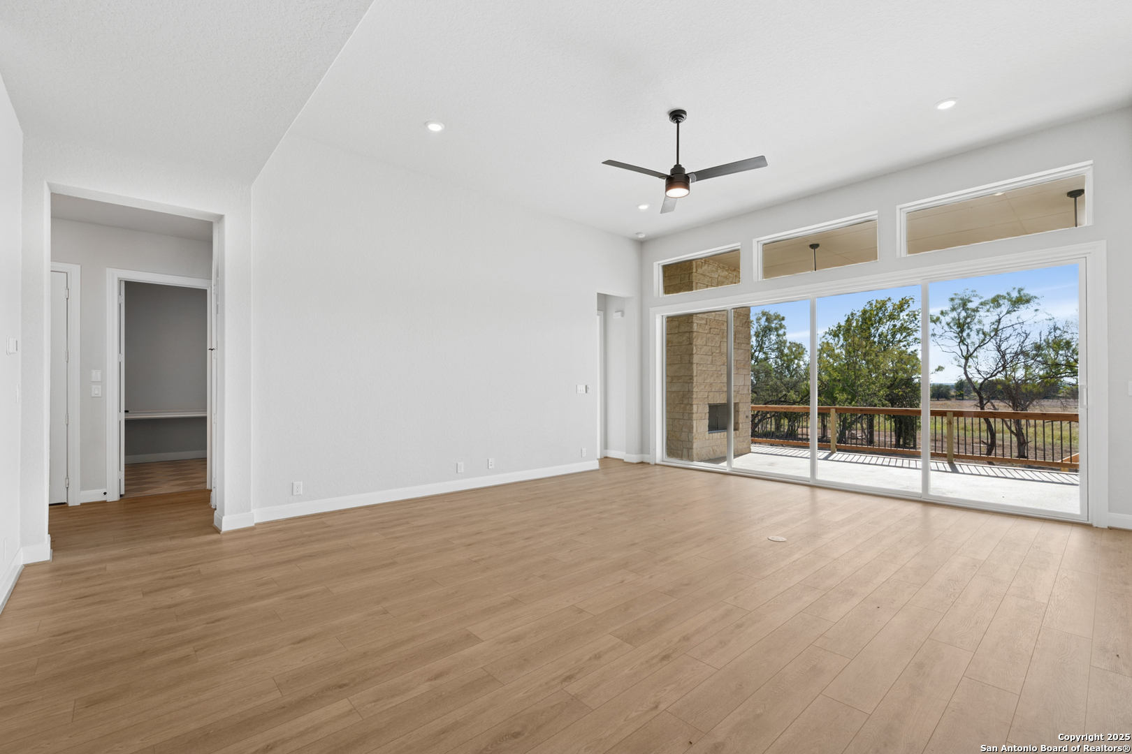 212 Brandon Cove Castroville, TX 78009 - Photo 28 of 36 a view of an empty room with wooden floor and a window