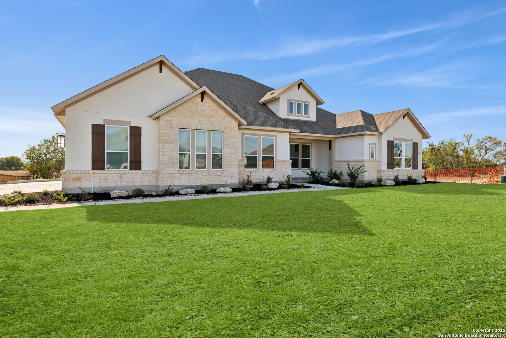212 Brandon Cove Castroville, TX 78009 - Photo 7 of 36 a front view of a house with a garden and trees