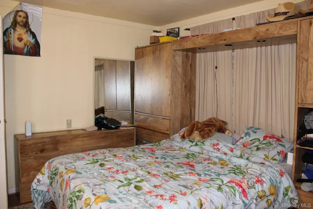 a bedroom with a bed and a dresser