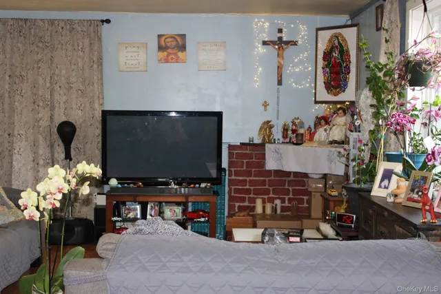 a room with painting on the wall and a potted plant