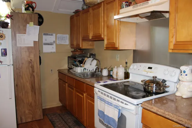 a kitchen with a sink a stove and cabinets