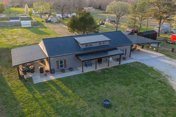 an aerial view of a house with patio swimming pool and outdoor seating