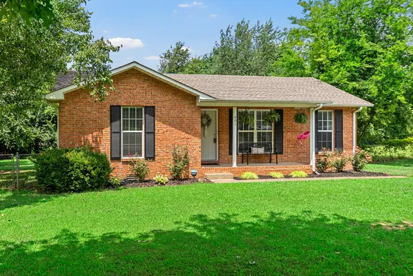 a front view of house with yard and green space