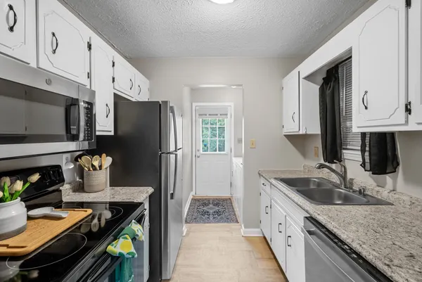 a kitchen with a refrigerator stove and sink