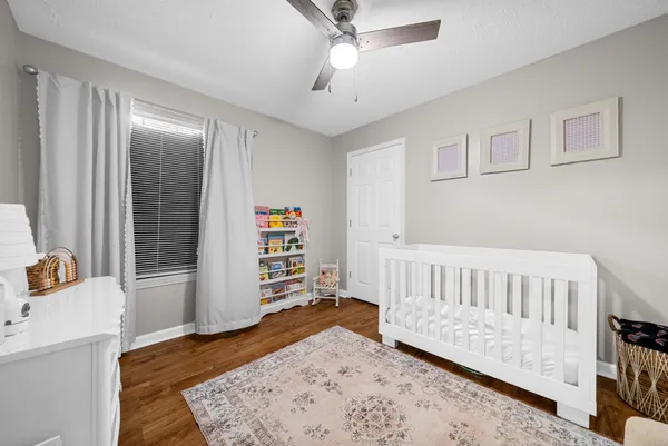 a bedroom with furniture and wooden floor