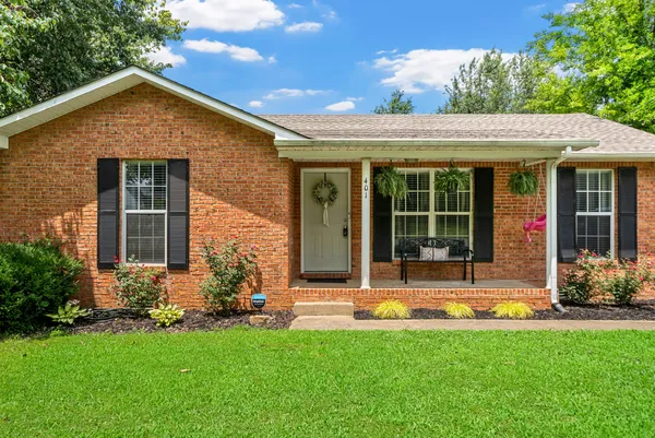 a front view of a house with a yard outdoor seating and garage