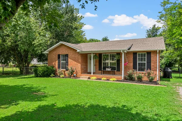 a front view of a house with a yard and porch