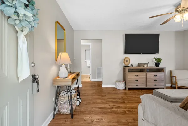 a living room with furniture and a flat screen tv